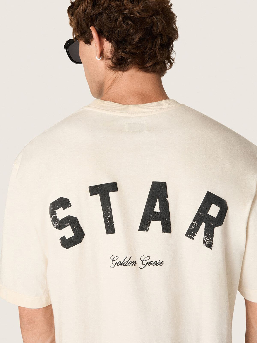 スターユニセックスコットンtシャツ。ヴィンテージホワイト、背面にブラックプリント。