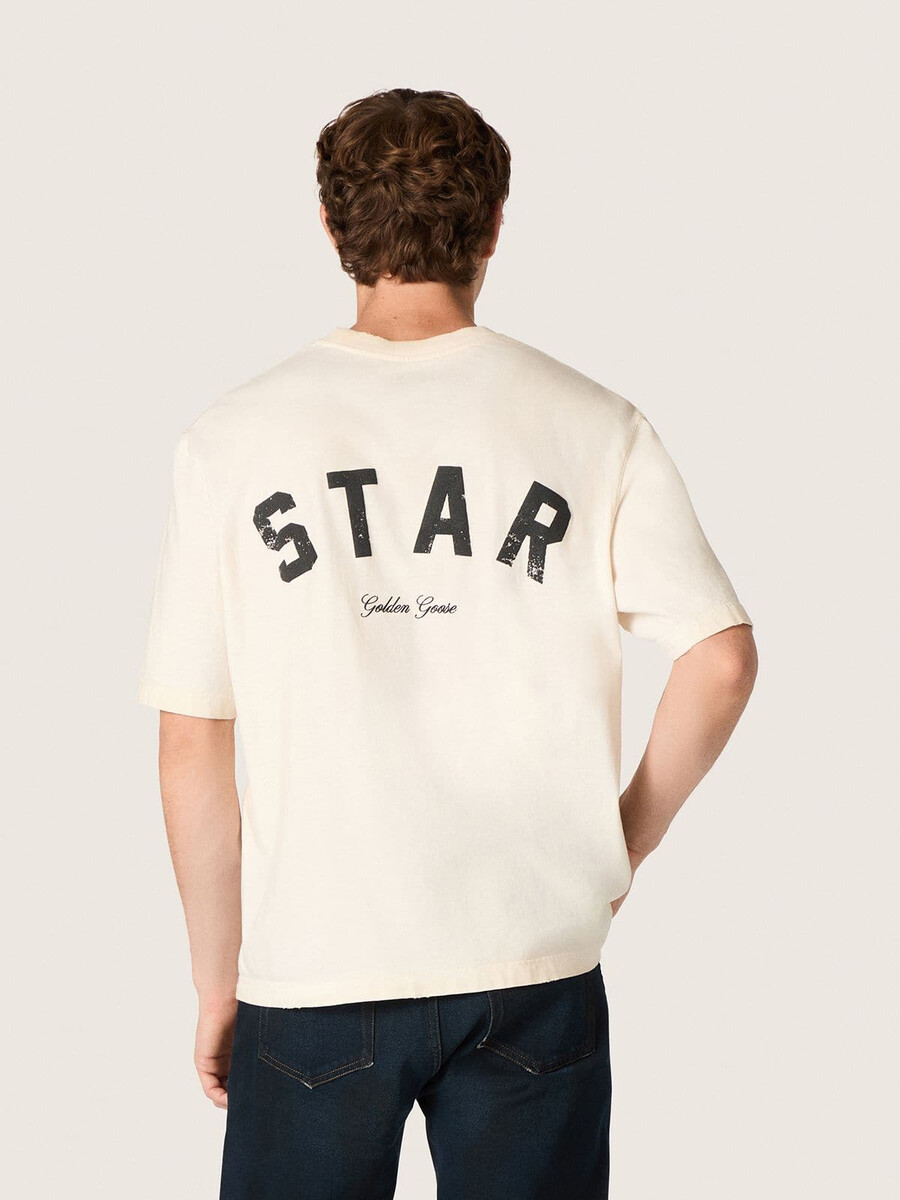 スターユニセックスコットンtシャツ。ヴィンテージホワイト、背面にブラックプリント。